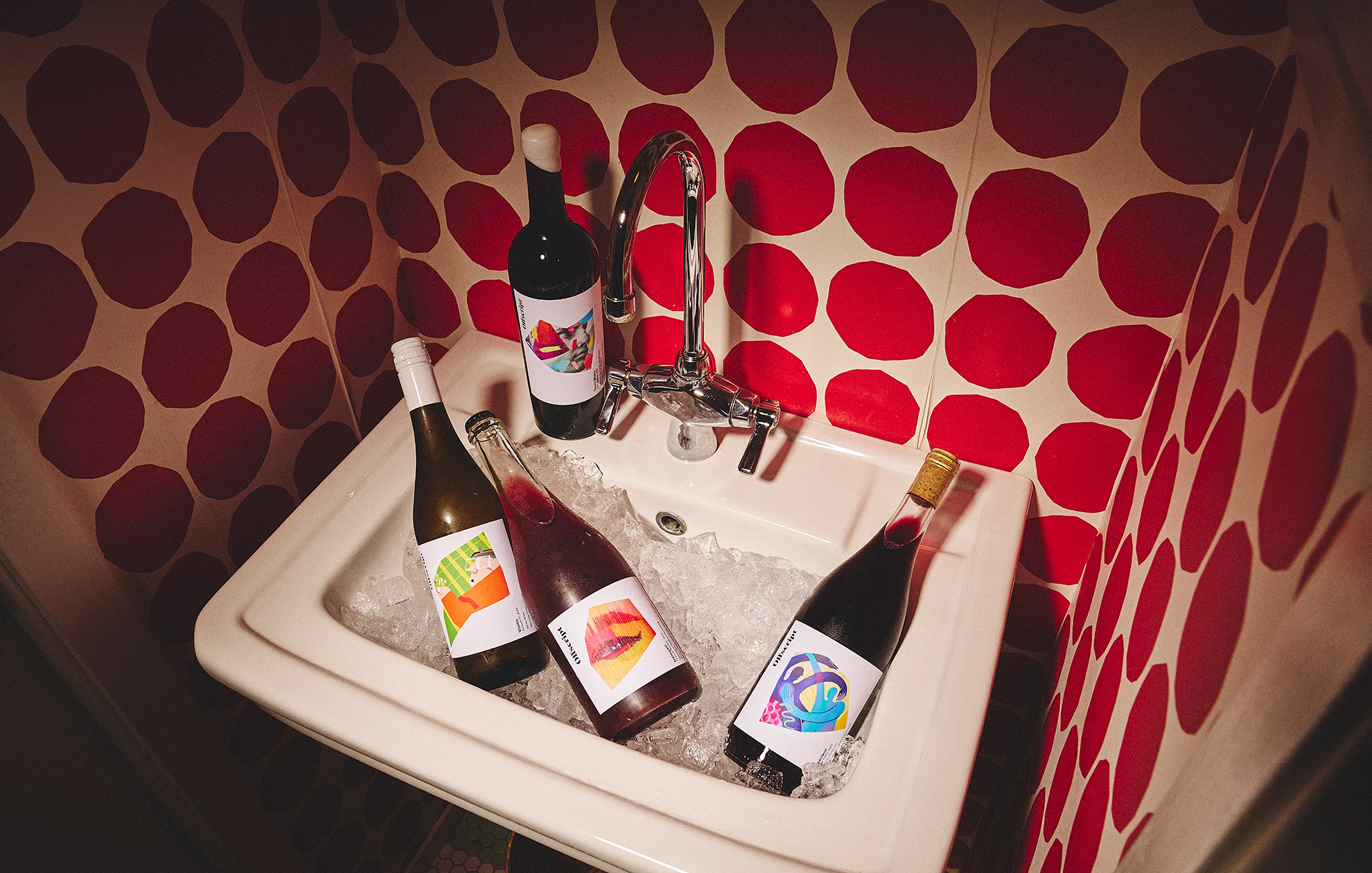 Offscript wine bottles in a sink filled with ice.
